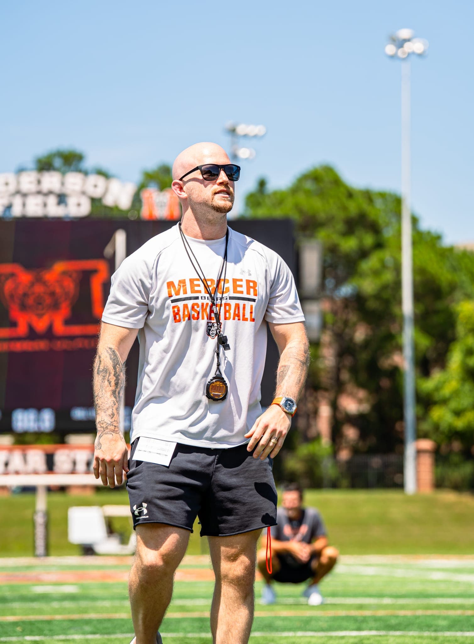 Colin DeClark timing a conditioning session on the field